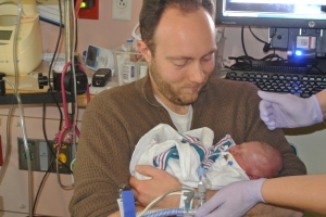Chris holds Mabel for the first time. 