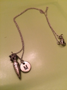 A necklace with a carrot and M for Mabel